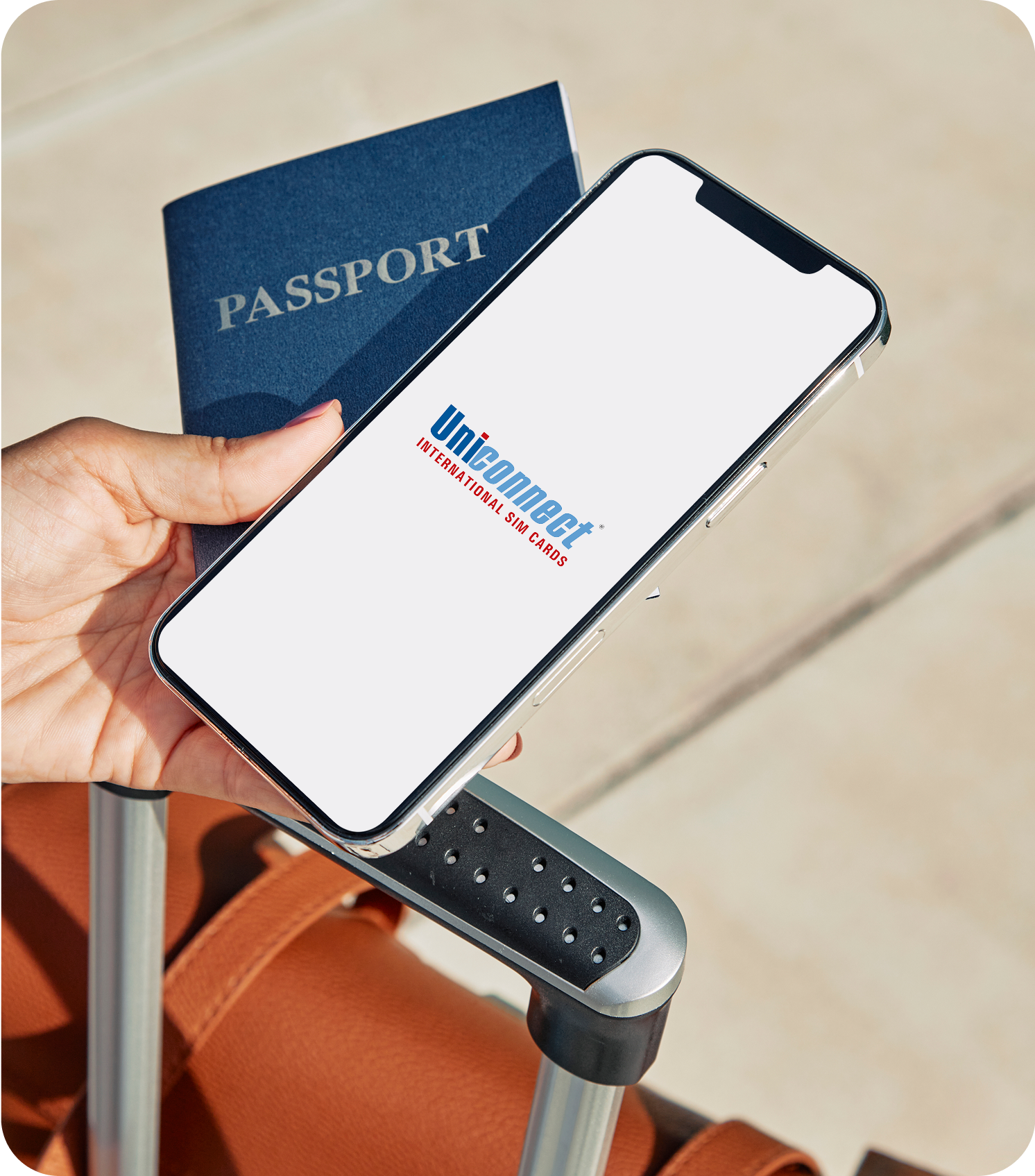 Hand holding smartphone with passport showing eSIM connectivity